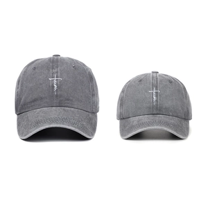 Two vintage washed grey cotton baseball caps featuring faith cross embroidery on a white background
