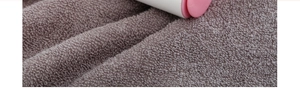 Macro shot of thick purple cotton towel loops with high-density texture and soft fibers