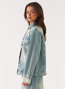Detailed side view showing vintage light wash denim jacket texture and silver metal buttons