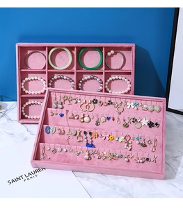 Detailed view of pink velvet jewelry trays featuring pearl bracelets and earrings