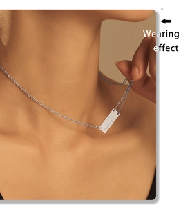Close-up of model wearing custom engraved silver rectangular pendant necklace on neck