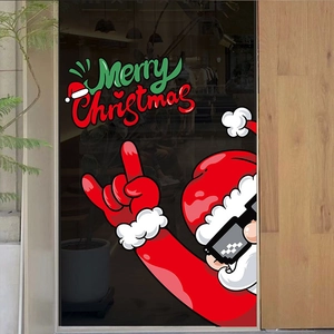 Detail of Santa Claus and Merry Christmas festive stickers on a clear glass shop window
