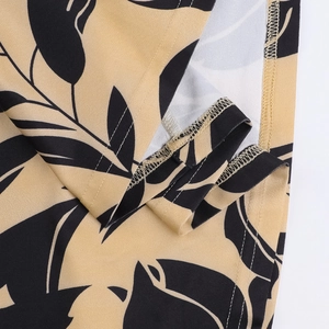 Detail shot of khaki floral dress showing reinforced edges and quality fabric texture