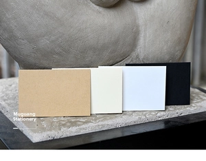 Mini rectangular kraft envelopes in four colors against an artistic stone background
