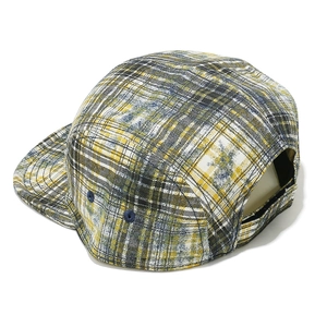Detail of yellow plaid camper hat featuring five-panel structure and flat brim style