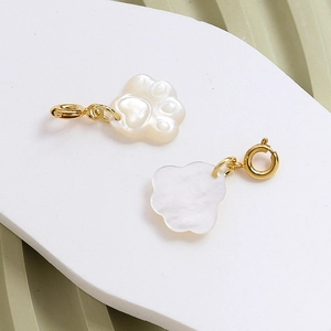 Detail view of cat paw shell pendant with gold plated clasp for DIY jewelry making