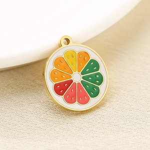Macro shot of 18K gold plated stainless steel fruit pendant with colorful enamel citrus detail