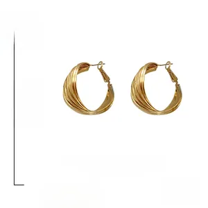 Detail of twisted geometric gold hoop earrings featuring dimensions and material specs