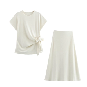 Detail view of cream knit set featuring a knot-tie round neck top and A-line midi skirt