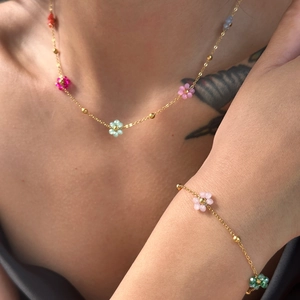 Floral stainless steel jewelry set with colorful translucent beads on a gold chain