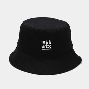 Close-up of white letter embroidery and fine stitching on a black cotton bucket hat