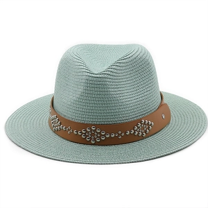 Detail of mint green straw fedora hat with silver studded leather band and woven texture