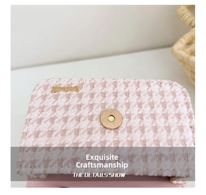 Macro view of pink houndstooth tweed fabric texture with golden magnetic clasp detail
