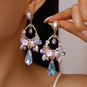 Vintage floral drop earrings with purple crystals and teardrop pendants worn by model