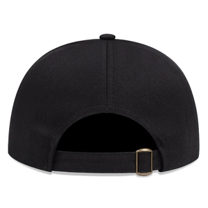 Detail view of the adjustable rear strap and copper metal buckle on the black baseball cap