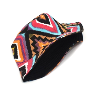 Detail view of colorful geometric ethnic print on reversible canvas bucket hat