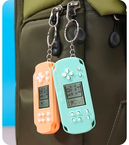 Mini retro handheld game console keychain in orange and cyan with LCD screen