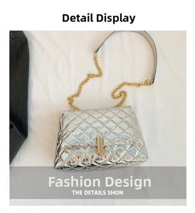 Close-up of silver quilted patent leather texture with gold metal buckle and chain