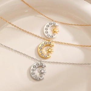 Detailed view of sun and moon pendant necklaces in gold and silver finish with crystals