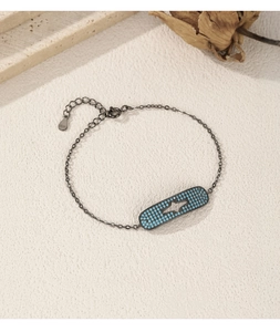 Macro detail of S925 silver bracelet with turquoise star pendant on textured stone