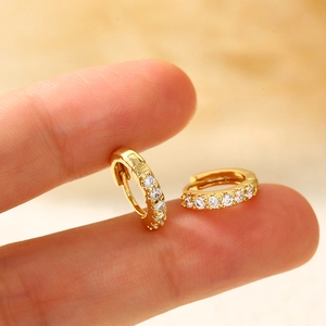 Minimalist gold hoop earrings with sparkling zircon stones in a classic hinged design