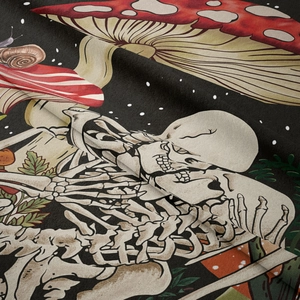 Close-up of soft gothic mushroom tapestry showing vivid skull and snail patterns