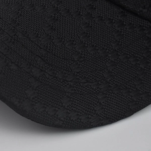 Macro detail of high-density black jacquard fabric with interlocking woven pattern