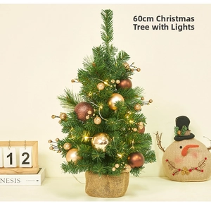 Detailed view of a 60cm mini Christmas tree with warm LED lights and golden ornaments