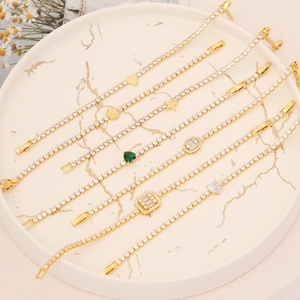 18K gold plated charm bracelets with heart and star pendants on marble surface