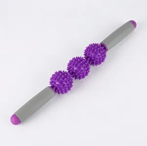Detail view of the purple muscle massage roller featuring three spiked therapy balls and handles