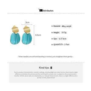 Detail view of teal marble acrylic drop earrings with gold metal and 6.5cm size markings