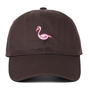 Detailed close-up of pink flamingo embroidery on dark brown cotton baseball cap fabric