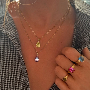 Golden teardrop necklaces with colorful gemstones and stackable rings for women