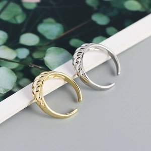 Macro shot of gold and silver S925 sterling silver croissant rings with twisted textures