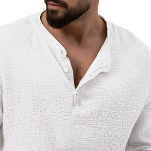 Close-up of white waffle texture fabric and three-button Henley neck on men's long sleeve shirt
