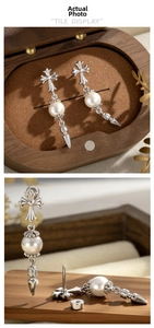 Detailed view of vintage punk earrings with cross studs, pearls, and silver spikes
