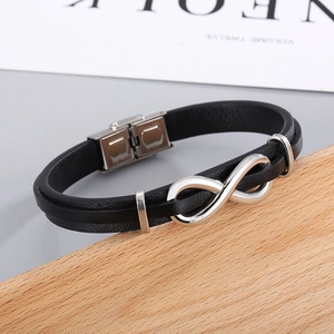 Detailed macro of black braided leather bracelet with stainless steel infinity clasp