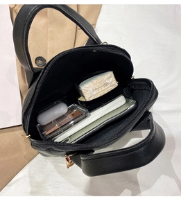 Interior view of the mini shell bag showing capacity for phone and cosmetics