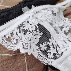French lace embroidery thongs in white and black with delicate floral patterns