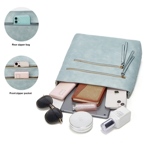 Detail view of light blue tote with front double zippers and rear pocket organization