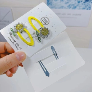 Detail of yellow sunflower BB clip with sparkling rhinestones and silver metal hairpin