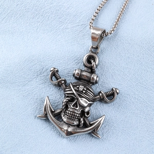 Detailed close-up of retro silver pirate anchor pendant with skull and cross swords
