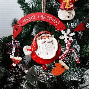 Handcrafted Christmas wreath decoration with Santa Claus and Merry Christmas banner