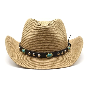 Detail of straw cowboy hat with leather band, turquoise gems and silver metal rivets