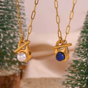 Detail of 18K gold-plated chunky chains with blue lapis and white pearl pendants