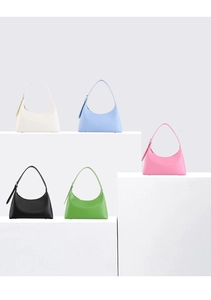 French style underarm bags in white, blue, pink, black, and green on white pedestals