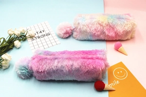 Detailed view of rainbow plush pencil case with colorful pompom and gradient tie-dye texture