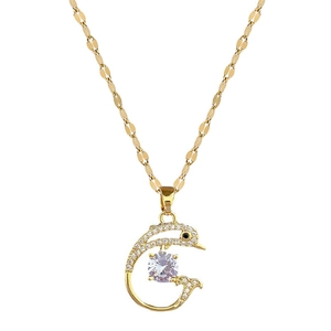 Golden dolphin necklace with lavender gemstone and pavé zircons on a white background