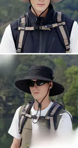Detail of adjustable windproof rope and wide brim on black outdoor sun hat