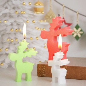 Christmas elk candle set in red and green colors with minimalist geometric silhouette design